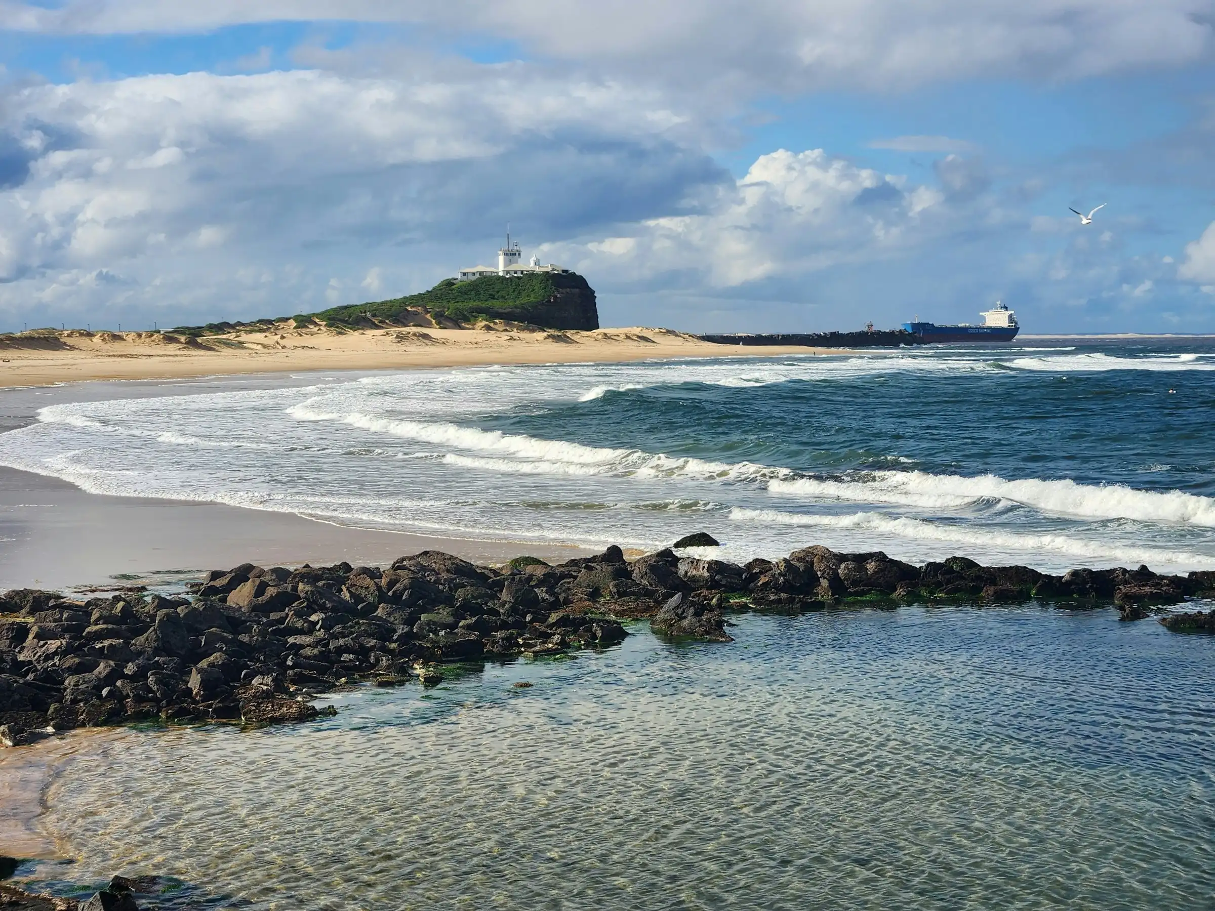 Nobbys Head and the breakwall from the beach at Newcastle